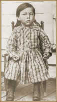 Photograph of small child in rocking chair
